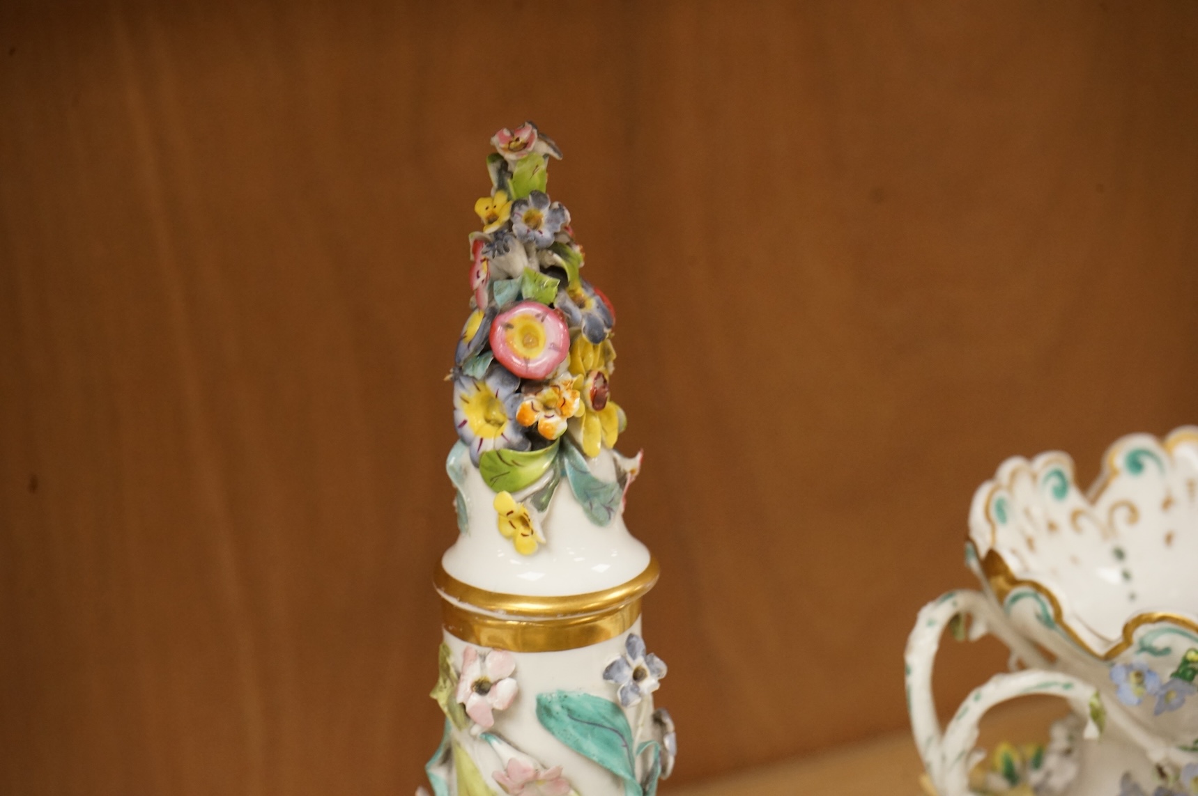 An English porcelain flower encrusted scent bottle and stoppers and a similar vase, c.1835, tallest 28cm